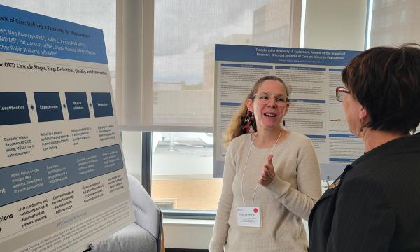 Presenters from the Poster Session show off their posters.