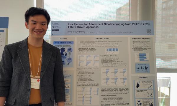Presenters from the Poster Session show off their posters.
