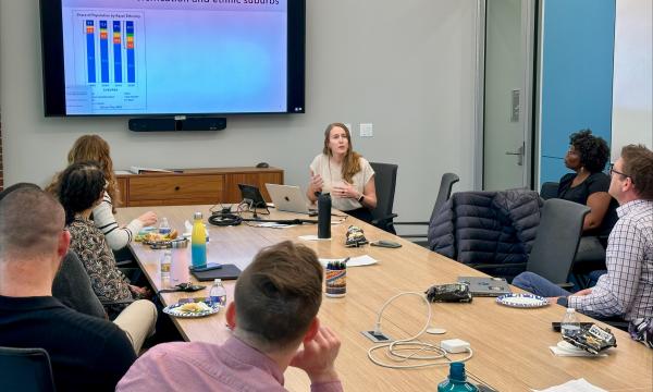 Julia Szabo, assistant professor of sociology and Latino studies, presenting about her research to the group.