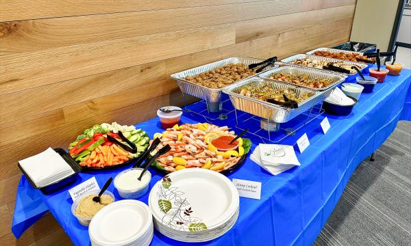 Table covered in food items for retirement party attendees.